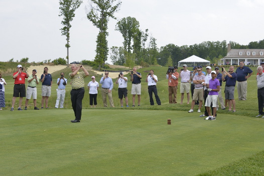 Jack Nicklaus hits a ceremonial tee shot to open Potomac Shores Golf Club in Prince William County, Va., alongside SSG Robbie Laux, a member of the Wounded Warrior program at Fort Belvoir, and 12-year-old Lauren Artis, a participant in The First Tee of Greater Washington, D.C.